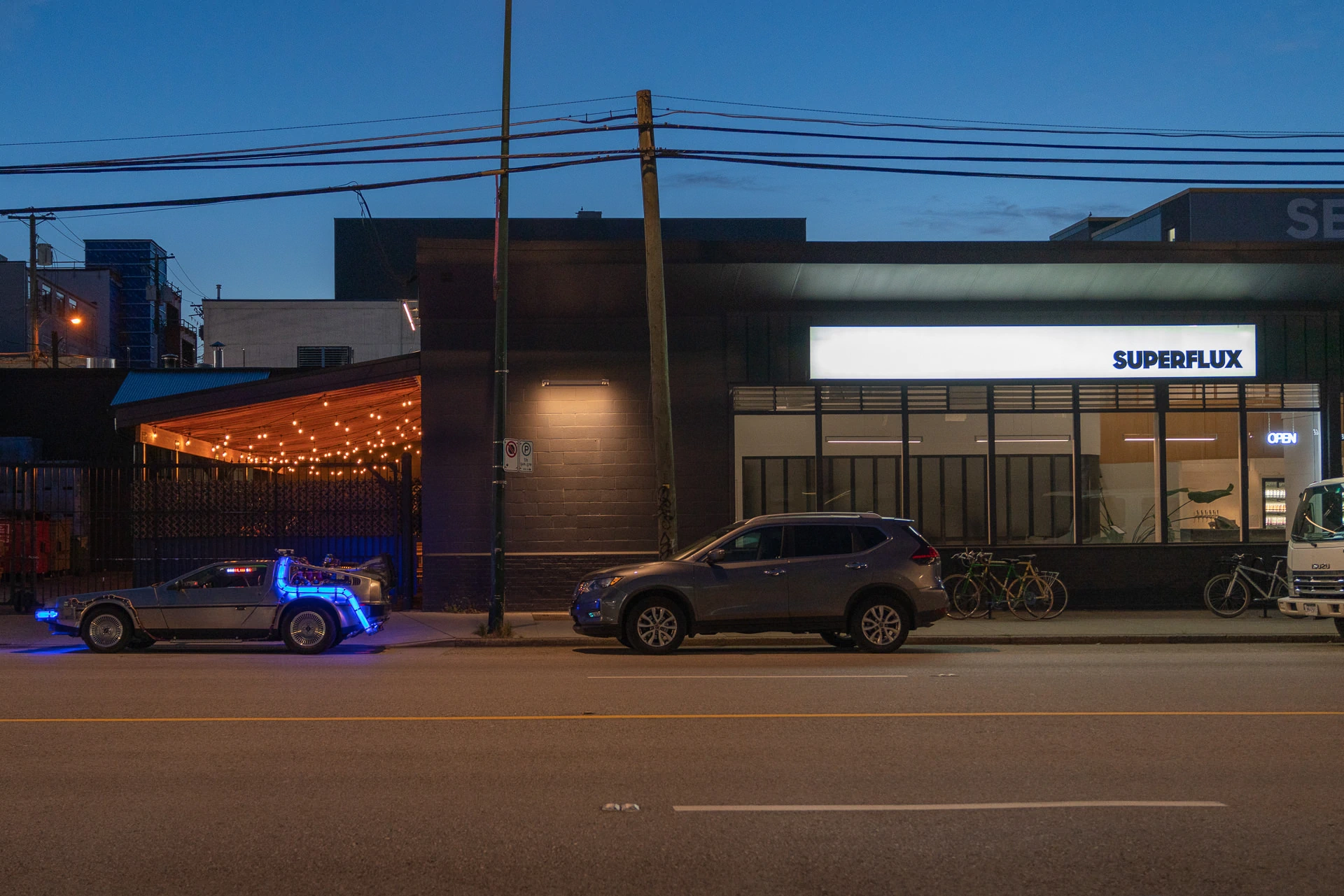 DeLorean 'Time Machine' replica with blue 'neon' flux bands parked at Superflux Beer, Vancouver, BC.